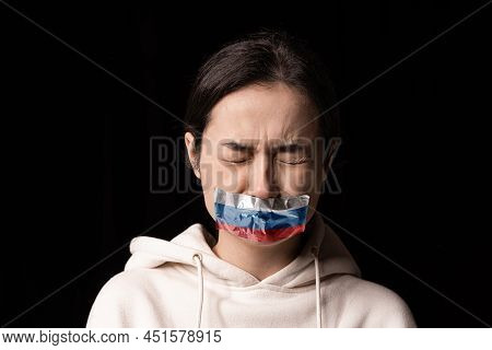 Half-legth Portrait Of Young Emotional Upset Girl With Three Colors Duct Tape Over Her Mouth Isolate