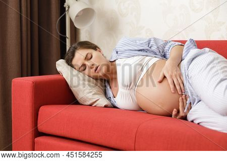 Young And Pregnant Woman At Home Feels Sick