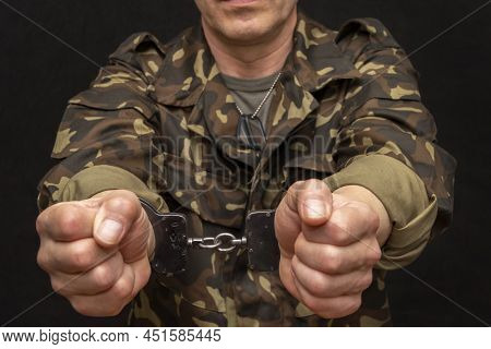 A Military Man In Handcuffs Holds An Army Badge In His Hand On A Dark Background, Selective Focus 37