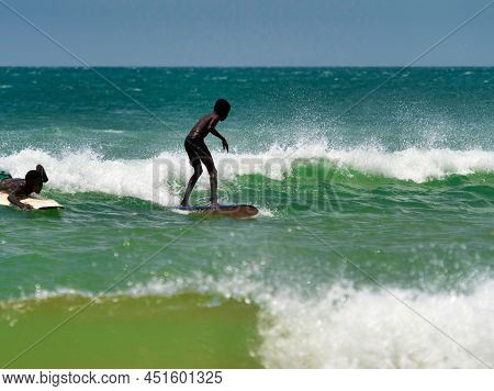 Somone, Senegal - November Circa, 2021. Unidentified Beginner Surfers On Sea , Trying To Find Good E