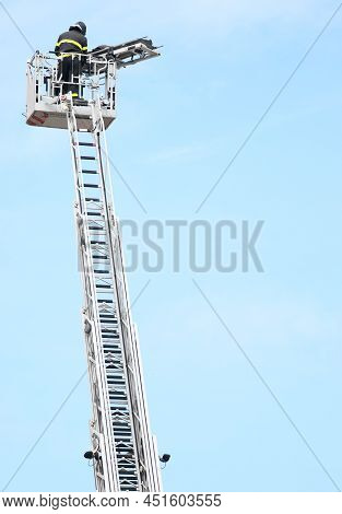 Brave Firefighter Who Saves The Injured Person Using The Truck With The Ladder Truck During An Emerg