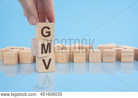 Hand Putting Wood Cube Block Increasing On Top With Letter G Upward Direction. Gmv Text. Financial, 