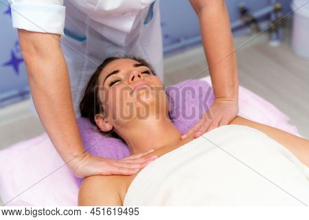 Facial Massage. A Woman Is Given A Massage In A Beauty Salon. Close-up.