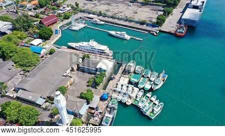 Aerial Of Beach, Pier, Boats, Resort And Businesses On Tip Of Tanyung Benoa Peninsula Above Dark Blu