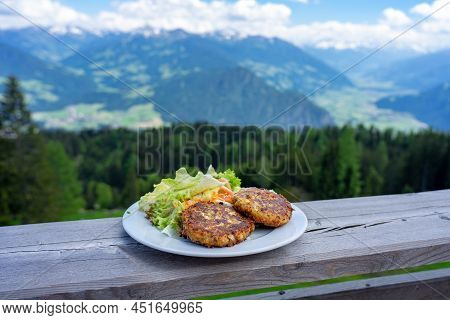 Traditional Local Kaspressknodel Cheese Dumpling In Tirol Austria With Mountain View Landscape