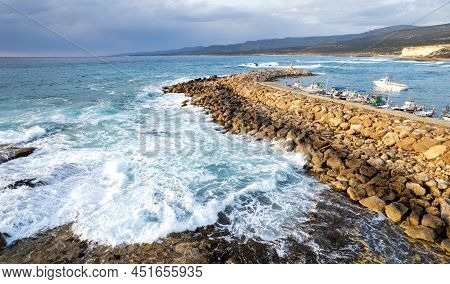 Aerial Drone View Of Fishing Boats Moored At The Harbor At Breakwater. Stormy Waves At Sea Peyia, Cy