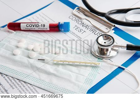 Closeup Of Blood Sample, Stethoscope And Thermometer