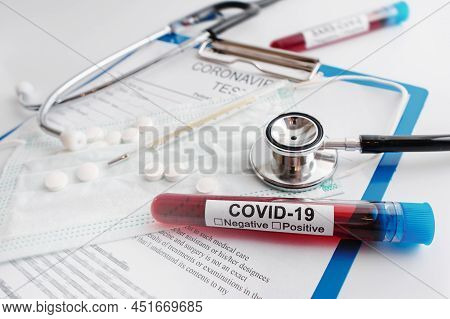 Closeup Of Blood Sample, Stethoscope And Thermometer