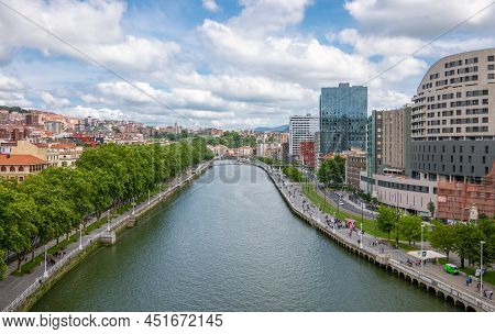 Bilbao, Spain - June 14, 2018:  View Of  The City On The Nervion River With The Zubizuri Bridge In T