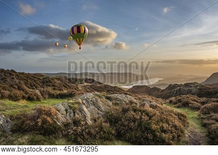 Digital Composite Image Of Hot Air Balloons Over Epic Autumn Sunset Landscape Image From Holme Fell 