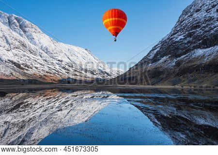 Digital Composite Image Of Hot Air Balloons Flying Over Beautiful Winter Landscape Image Of Loch Ach