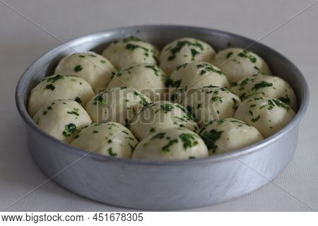 Dinner Rolls Dough Ready To Go To The Oven Prepared In A Circular Bake Tin. Glazed With Butter And C