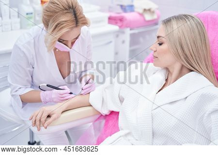 Skin Doctor In Medical Mask Carrying Out Electrocautery