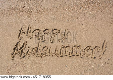 Words Happy Midsummer Handwritten On A Sandy Beach