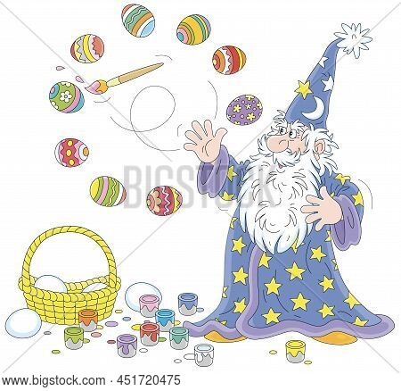 Old Wizard With A Big White Beard Coloring And Decorating Easter Gift Eggs With A Magic Flying Paint
