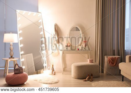 Large Mirror With Light Bulbs And Dressing Table In Stylish Room. Interior Design