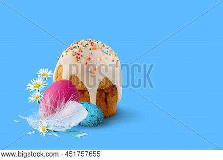 Easter Cake And Easter Eggs With Flowers On A Blue Background