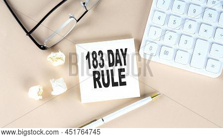 183 Day Rule Text On Sticky With Pen ,calculator And Glasses On Beige Background