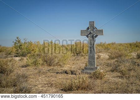 Celtic Stone Cross In The Desert With A Clear Blue Sky