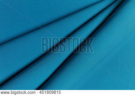 Blue Crumpled Or Wavy Fabric Texture Background. Abstract Linen Cloth Soft Waves. Gabardine Wool Fab