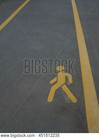 Yellow Traffic Sign. Asphalt Road For Pedastrians Marked With Special Sign. Pedestrian Symbol Painte