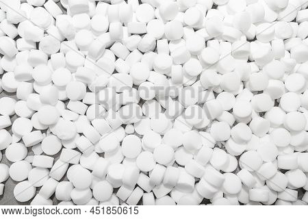 Background made of salt tablets for a water softener, large round cubes.