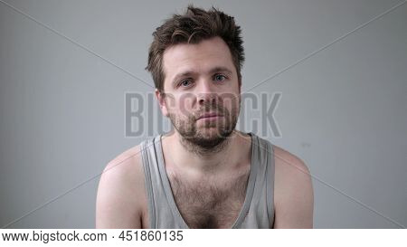 Serious Young Man Lookingat Camera Without Emotions.