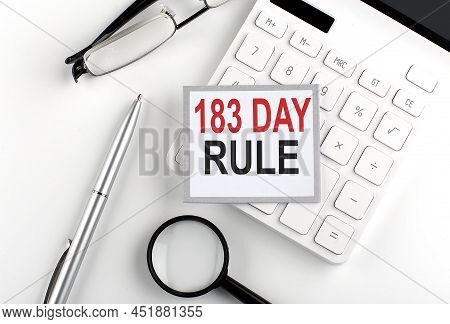 183 Day Rule Text On Sticker With Calculator, Glasses And Magnifier