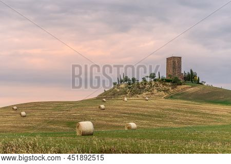 Tuscany - Italy. June 04, 2021: The Bales Of Hay On The Approaches To The Renaissance Torre Tarugi O