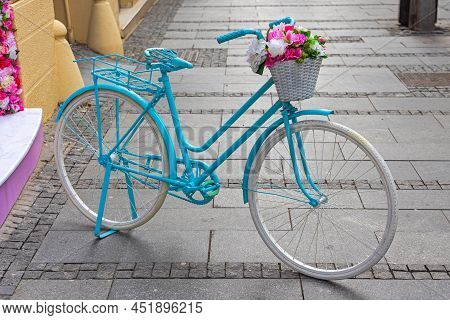 Light Blue Girly Bicycle Parket At Street With Flowers Basket