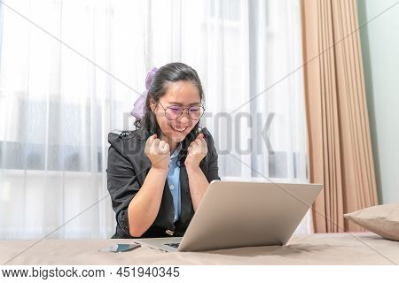 The Woman Was Excited To Look At A Laptop Which Was Laid On Her Bed Because Of Her Winning A Lottery