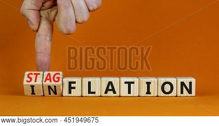 Stagflation Or Inflation Symbol. Businessman Turns Cubes And Changes The Concept Word Inflation To S