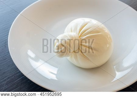 Buratta Cheese On A White Plate. Side View From Above