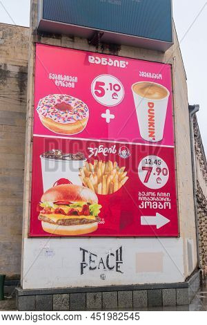 Kutaisi, Georgia - March 19, 2022: Dunkin Donuts And Wendy's Offers Advertisement.