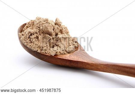 Fresh kencur roots and ground kencur powder on white background