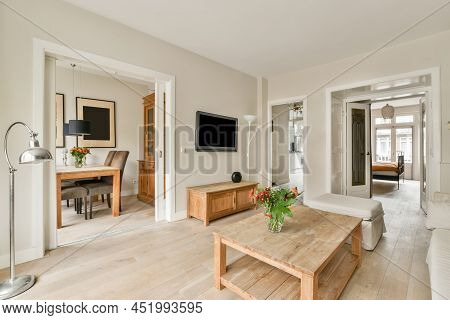 Spacious Living Room In A Casually Stere With Lots Of Lamps And Necessary Furniture