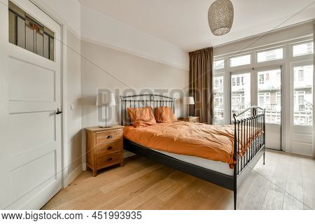 Bedroom With A Large Metal Double Bed And Two Bedside Tables