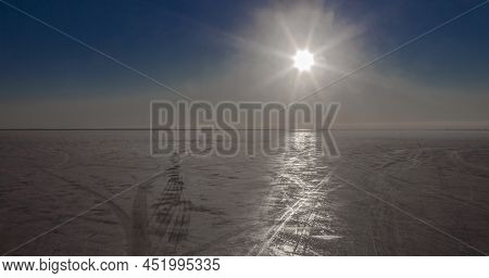 Ice And Sky Landscape Of The Gulf Of Finland On Sunny Frosty Day. Bright Sun Over The Ice Cover Of T