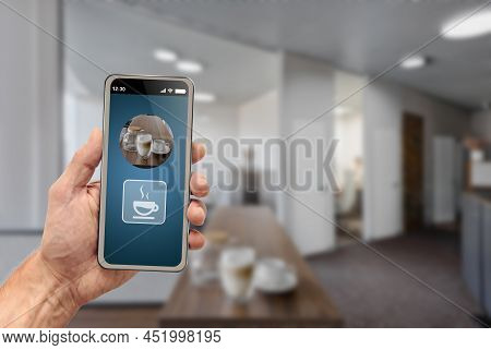 Man Cotrolling Coffe Machine With Mobile Phone Application In The Morning