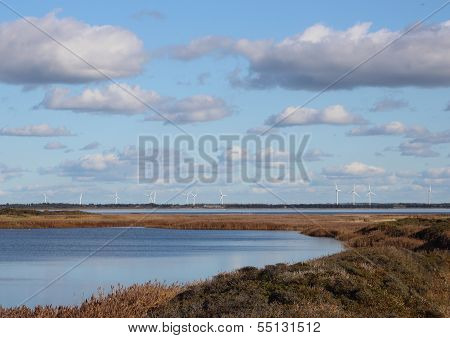 Landscape Of Danish Fjord With Windmills In The Horizon