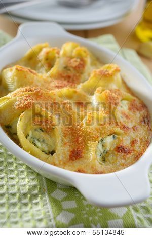 Baked lumaconi with ricotta, spinach, and grated Parmesan cheese
