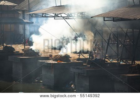KATHMANDU, NEPAL - DEC 3: During the cremation ceremony along the holy Bagmati River in Bhasmeshvar Ghat at Pashupatinath temple, Dec 3, 2013 in Kathmandu, Nepal.