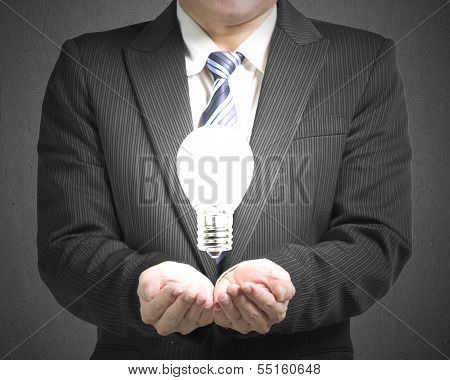 Palm opening business man with lighting blub