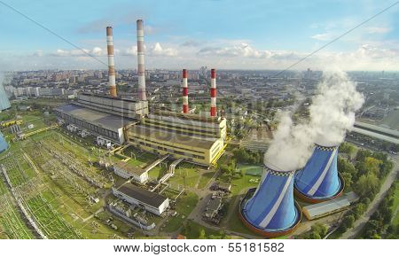 Territory of power plant with many pipes at sunny day. View from unmanned quadrocopter.