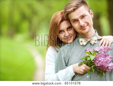 Couple In Love In Blooming Apple Trees Garden, Smiling . Valentine's Day