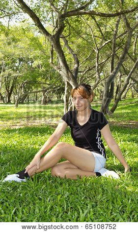 Young Women Sitting With Squirm Her Legs On Vertical