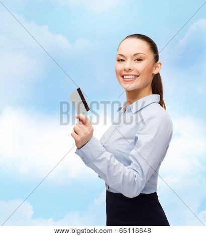 business and bank concept - smiling businesswoman showing credit card