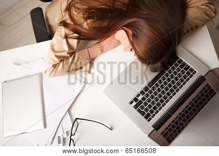 working woman sleeping on laptop in the workplace