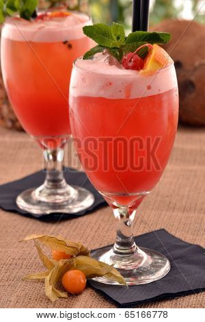 Fruit punch cocktail drink and fruits.