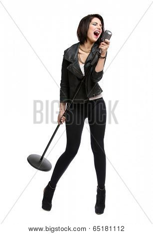 Full-length portrait of rock singer wearing leather jacket and keeping static mike, isolated on white. Concept of rock music and rave